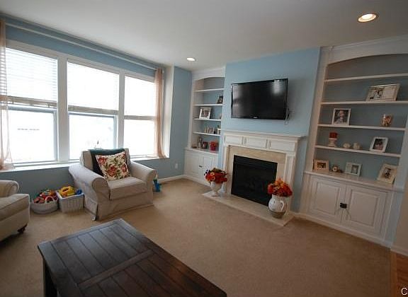 Beautiful Great Room with custom built-in shelving and cabinets;