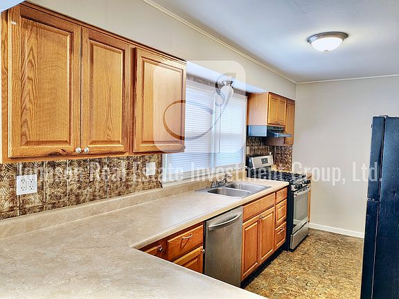 Large kitchen with lots of stainless steel gas range.