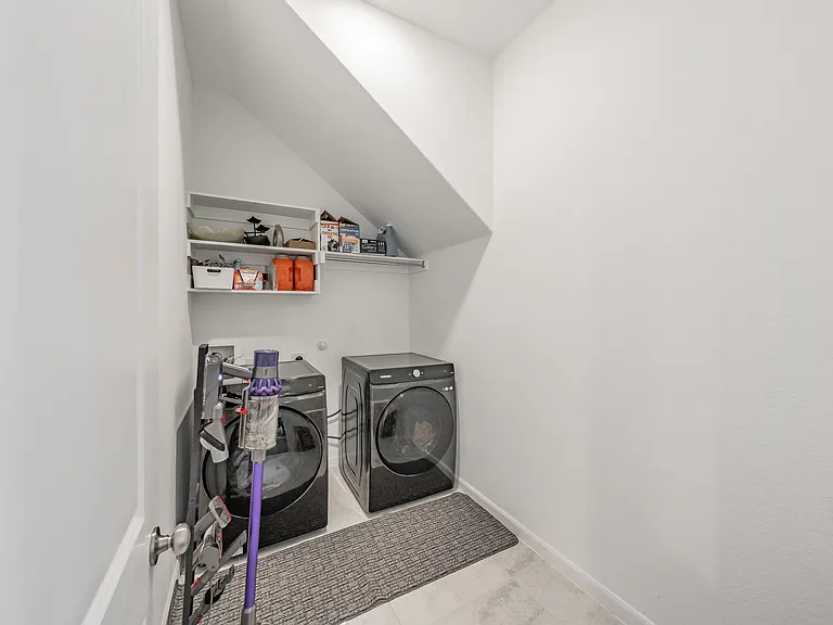 large laundry room offers extra storage near the kitchen