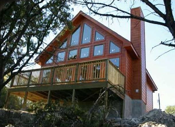 THIS PICTURE WAS TAKEN WHEN THE HOME WAS COMPLETED.  THE TREES NOW ARE GROWN AND MATURE.  AWESOME CHALET STYLE HOME THAT HAS A REAL MOUNTAIN FEEL TO IT.  IF THE TEXAS HILL COUNTRY VIEWS WERE NOT SO VISIBLE YOU MIGHT FEEL THINK YOU WERE IN COLORADO.