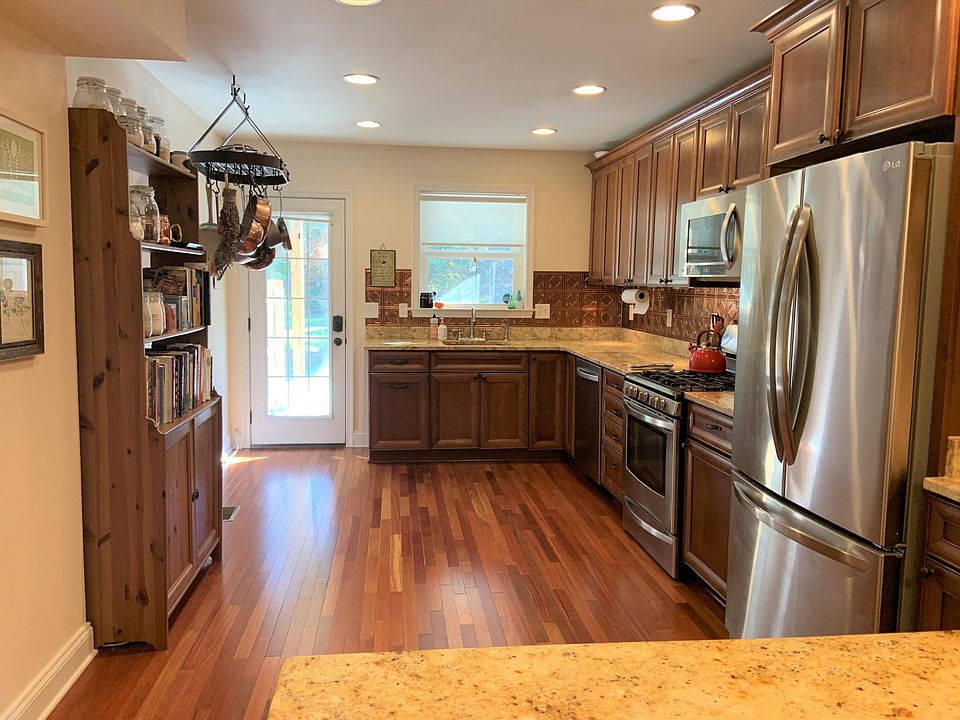 Kitchen has stainless appliances , gas stove, granite counters with faux copper backsplash made from easy-to-clean material. Pot rack stays with the house!