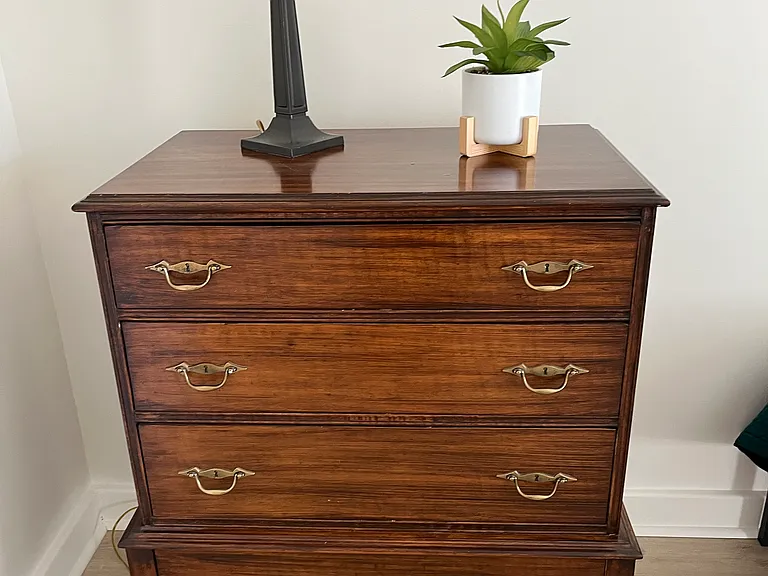 Second bedroom bureau plus storage wall with drawers.