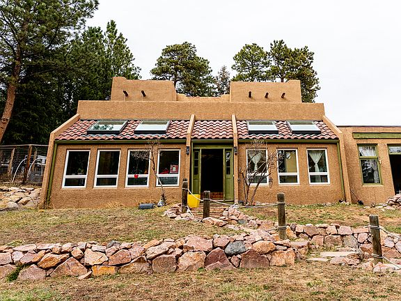 Front of home with entrance and sunroom windows/skylights