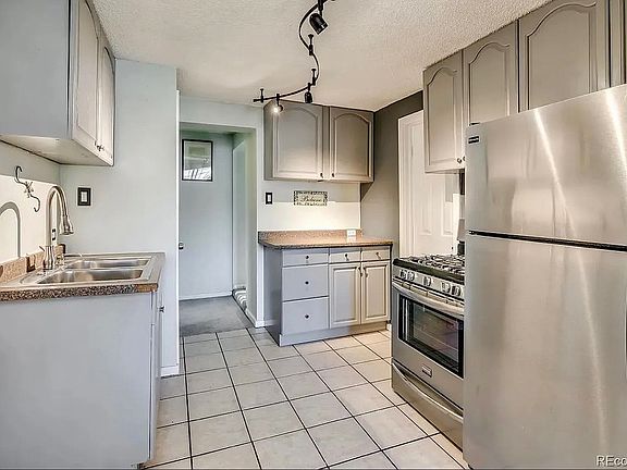 Updated kitchen with stainless steel appliances, gas range, ample cabinetry, and tile flooring for easy maintenance. Efficient layout makes cooking and meal prep a breeze.