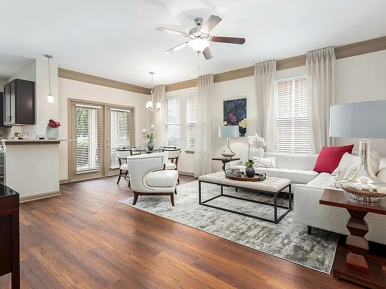 Spacious open-concept living and dining area with hardwood-style flooring, abundant natural light, and elegant finishesluxury apartment living in Charlotte.