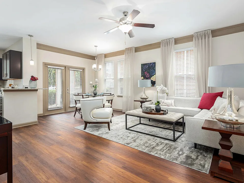 Spacious open-concept living and dining area with hardwood-style flooring, abundant natural light, and elegant finishesluxury apartment living in Charlotte.