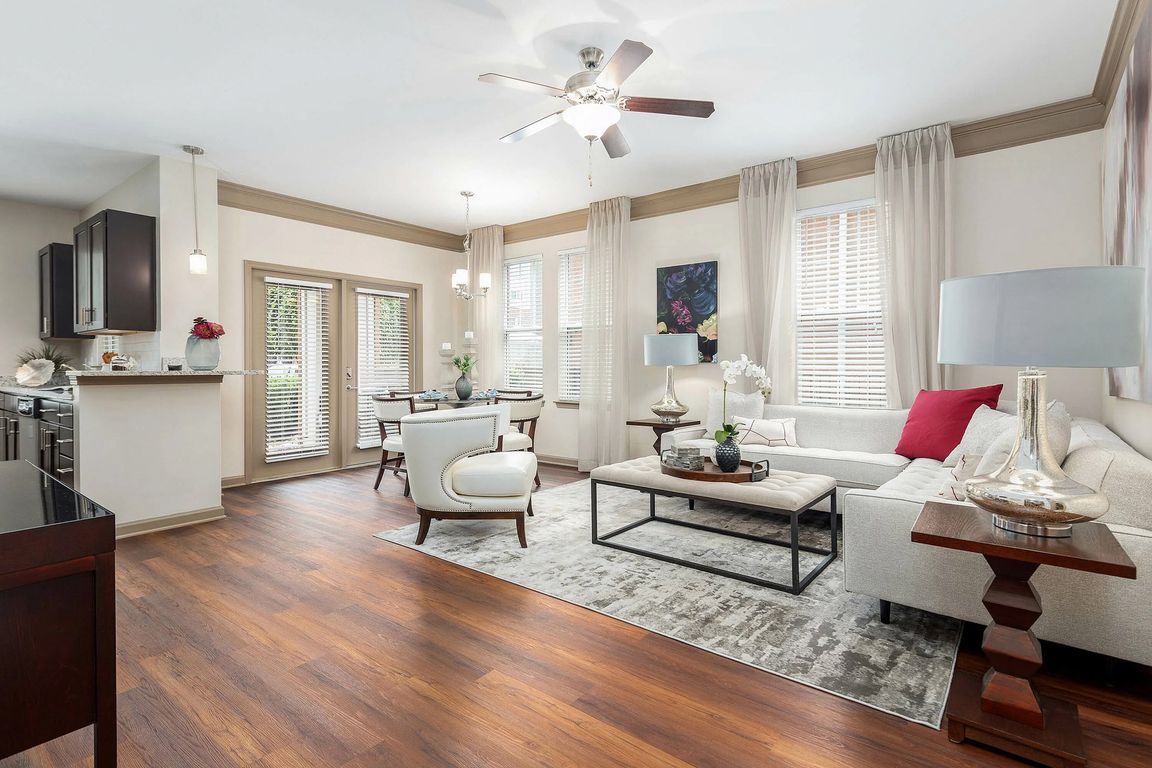 Spacious open-concept living and dining area with hardwood-style flooring, abundant natural light, and elegant finishesluxury apartment living in Charlotte.
