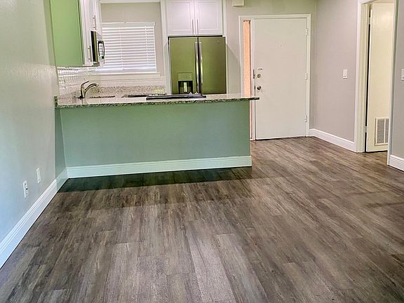 Open concept living room & kitchen. Large laundry room for storage and convenience.