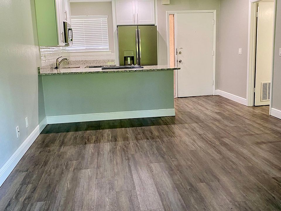 Open concept living room & kitchen. Large laundry room for storage and convenience.