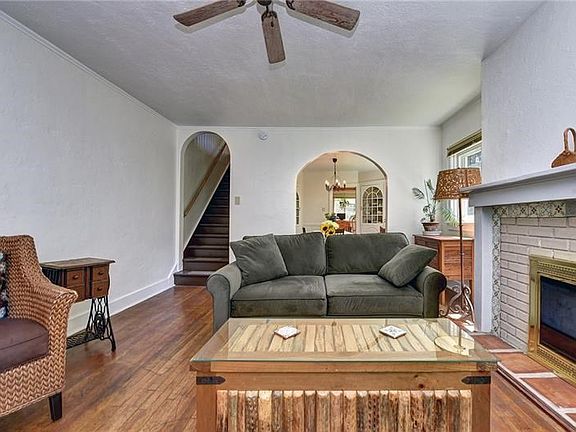 Fireplace detail and view into dining room.
