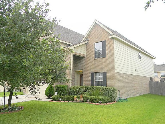2 car garage, covered front patio, and decorative window shutters greet you at entry.