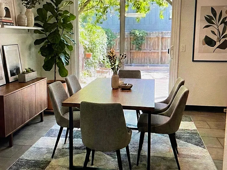 Dining area adjacent to kitchen with sliding door virtually staged