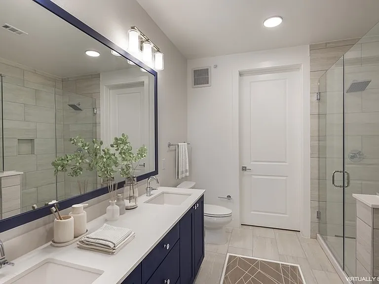 AMLI Branch Park staged bathroom with blue cabinets