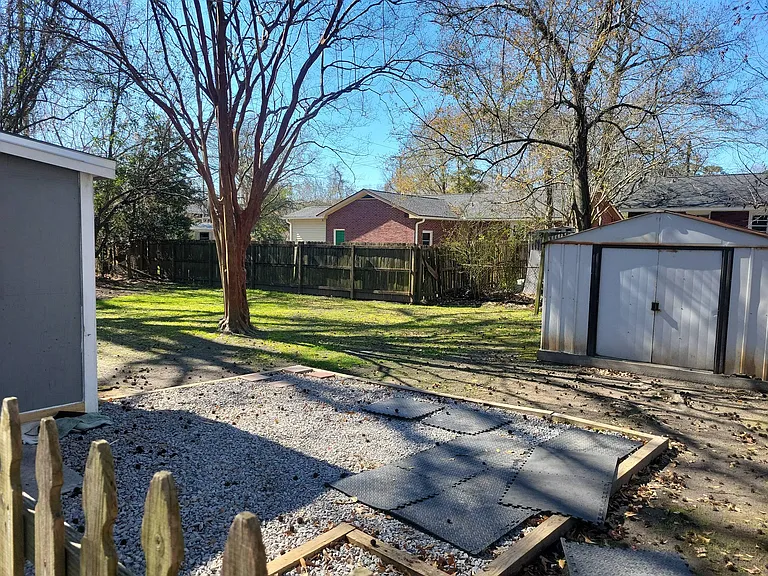Backyard and gravel patio, and storage building