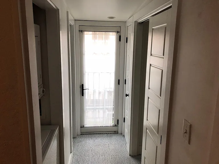 Second floor hallway with laundry and closets.