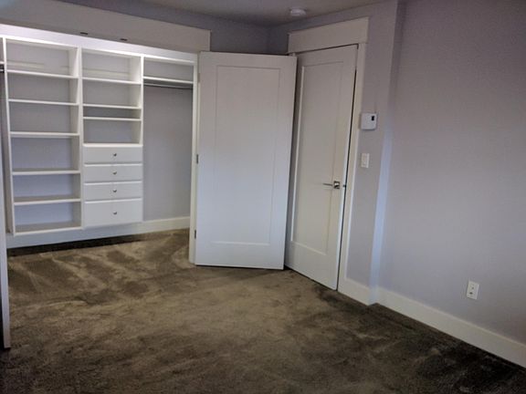 View of walk in closet adjacent to bedroom