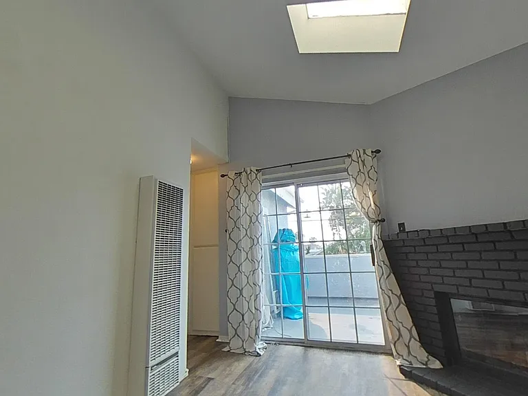 Living room with fireplace and balcony view