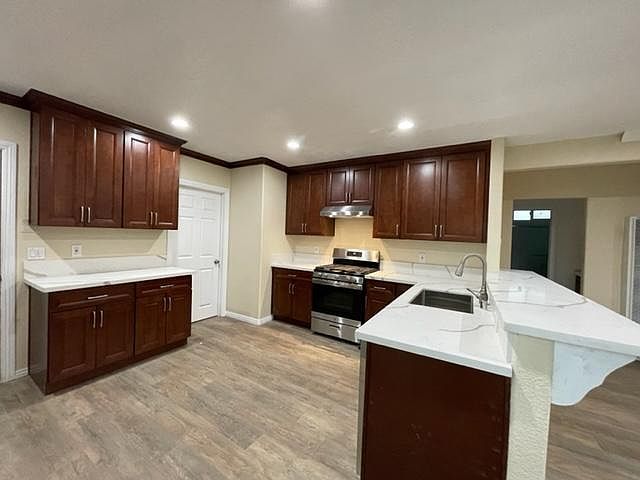 Completely new kitchen with quartz countertops, walnut cabinets, and stainless steel appliances