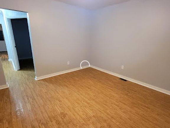 Bright living area with ceiling fan and durable flooring.