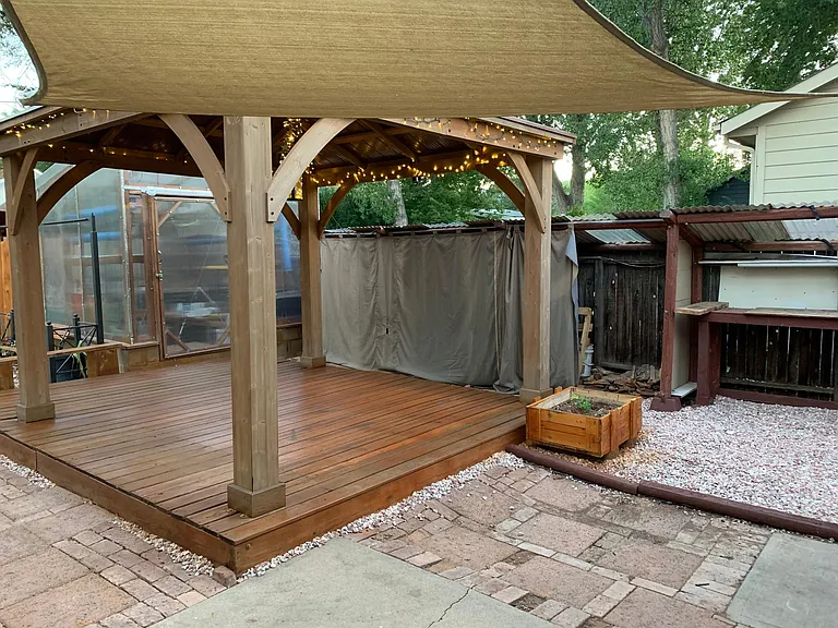 Gazebo with lighting for relaxing and entertaining outside, covered wood storage for the fireplace (up to 2 cords), green house (aquaponics or dry bed) available for use year round growing