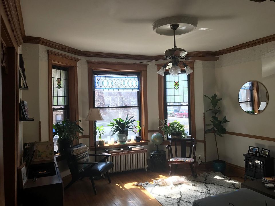 Front room with bay window and stained glass.