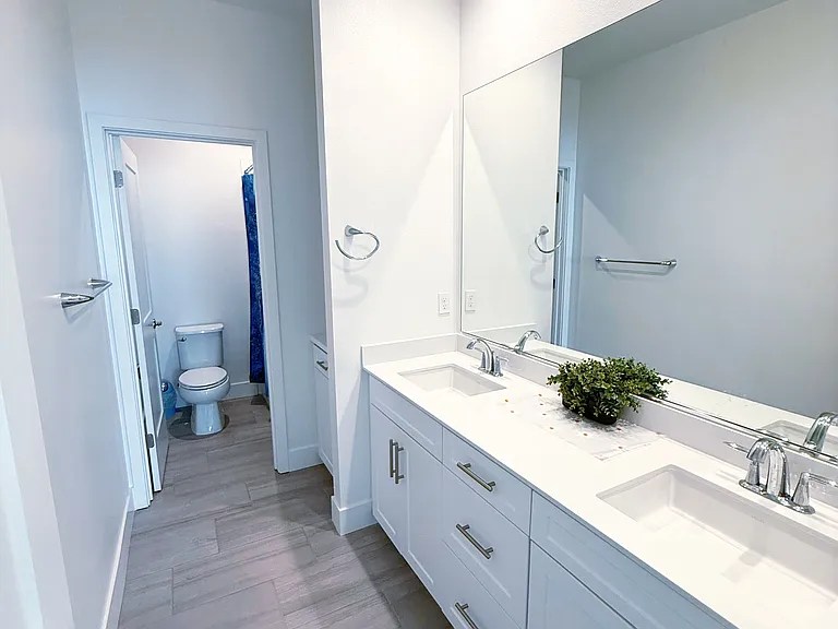 Upstairs private bathroom with double sinks and bathtub with shower ahead