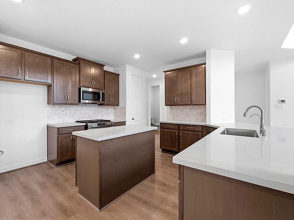 Bright kitchen and family room with the AW Collection Roosevelt and a generous center island, ideal