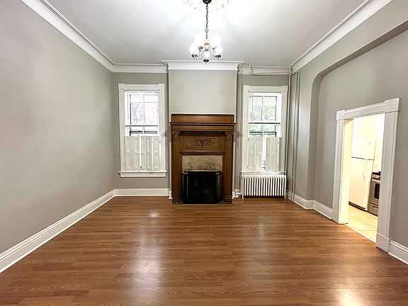 Beautiful high ceilings, wooden fireplace, and moldings.