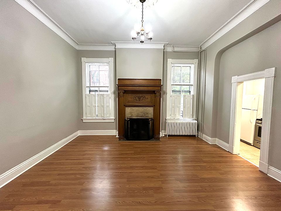 Beautiful high ceilings, wooden fireplace, and moldings.