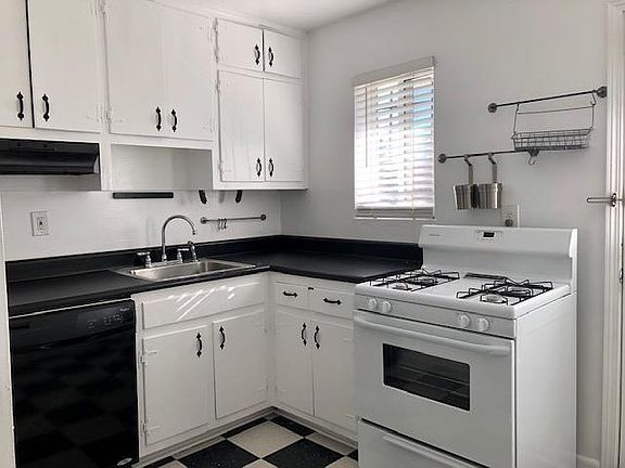 Sunny kitchen with dishwasher and gas range