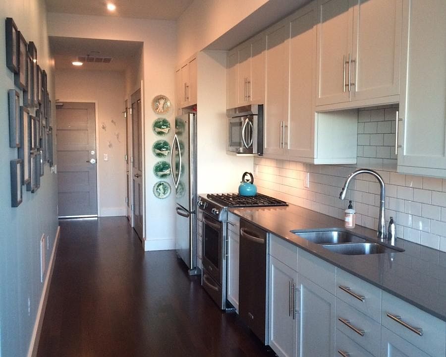 View of front door and gallery kitchen