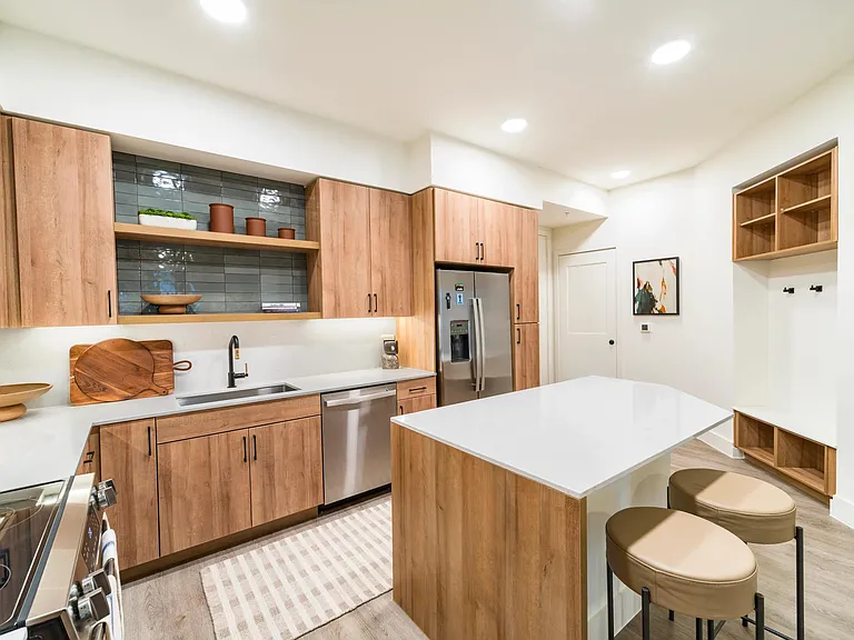 Savor a stylish kitchen at Modera St. Paul, featuring warm wood cabinetry, sleek countertops, and an island perfect for dining or entertaining in Dallas.