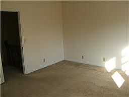 Master with vaulted ceilings, windows look over backyard.