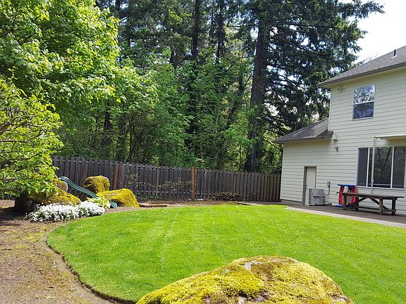 Large beautiful backyard with entrance to garage