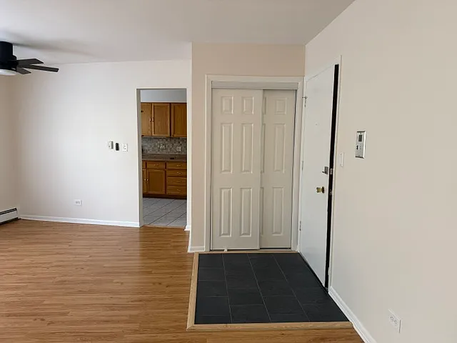 Living Room (Facing entryway coat closet with hanging storage and built in shoe rack)