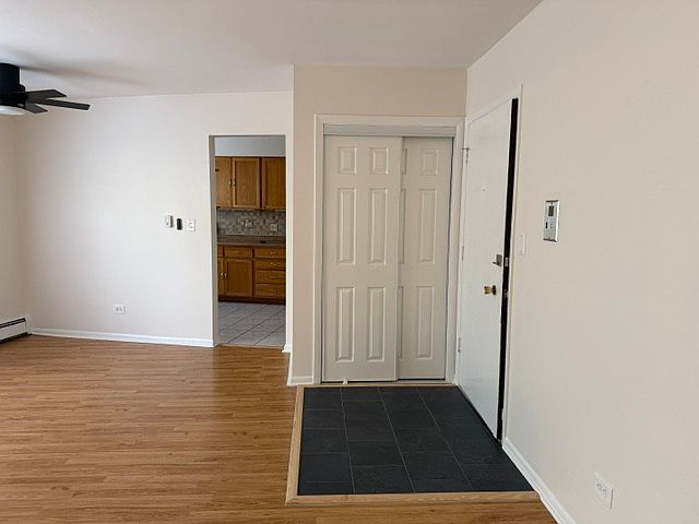 Living Room (Facing entryway coat closet with hanging storage and built in shoe rack)