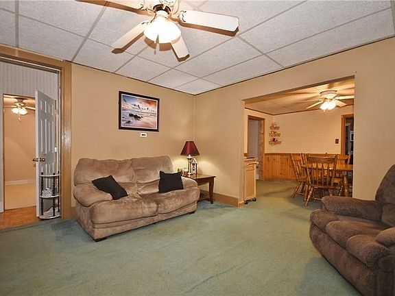 Front entry door is to the far left. Visible door on left is for the smaller bedroom. To the right is the dining room. The 2 oth