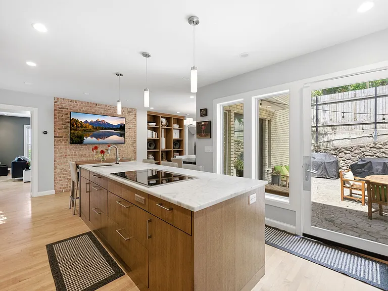 Spacious kitchen with lots of windows and patio entrance as well as adjacent dining room.