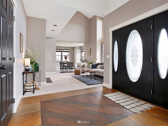 Custom tiled entryway and solid wood doors.