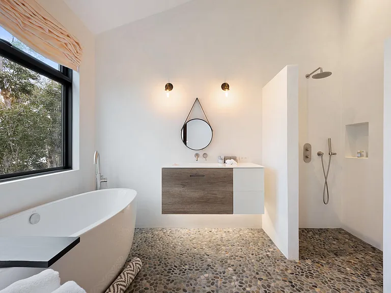 Relax and unwind in the luxurious tub with a glass of wine.