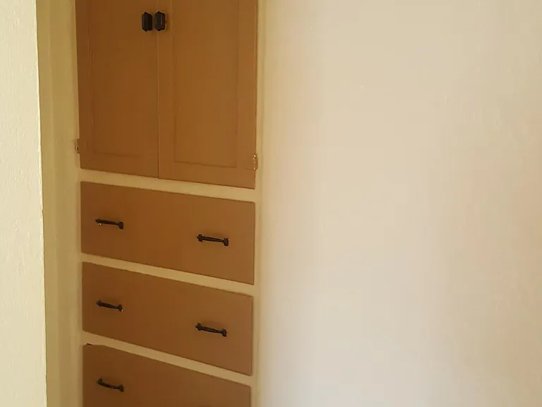 Hallway with built-in linen closet