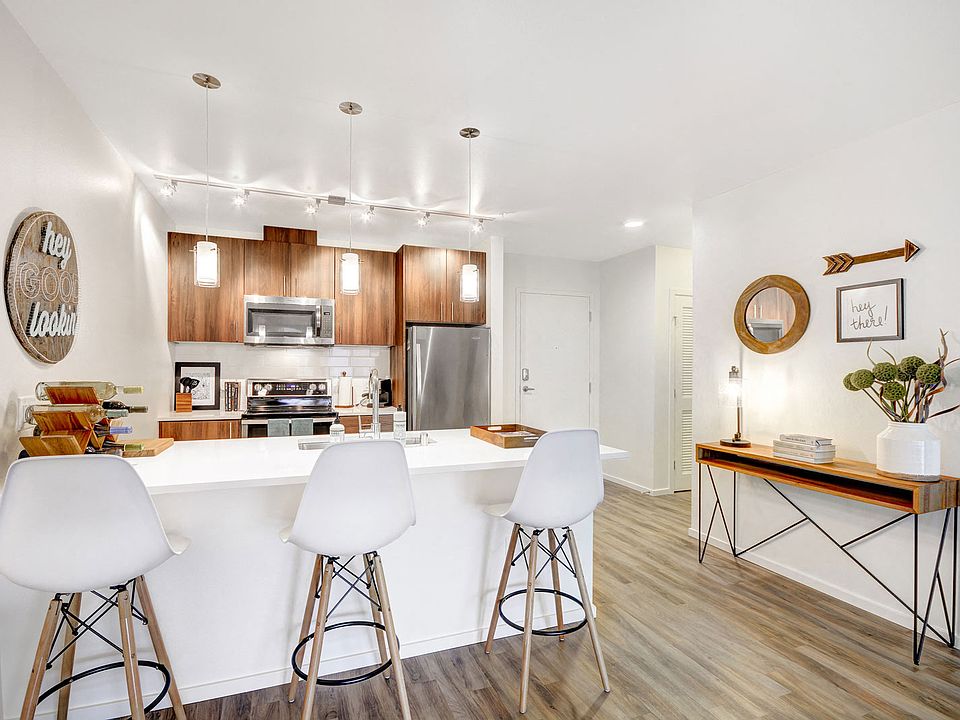 Bright, functional kitchens with stainless steel appliances and quartz countertops