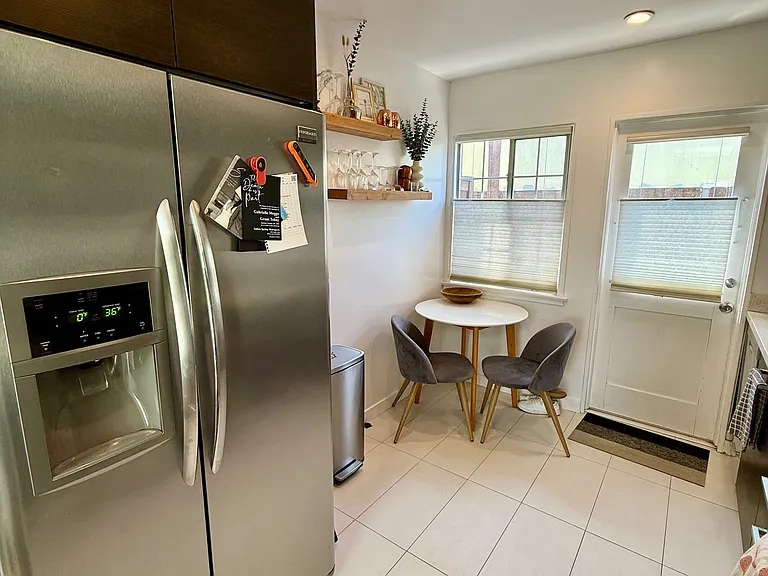 Large refrigerator with ice maker and small dining area