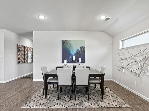 Dining room in the Oscar home plan by Trophy Signature Homes - REPRESENTATIVE PHOTO