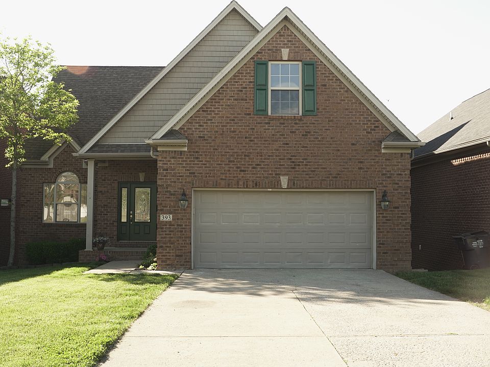 393 Hays Blvd, looking North to the large picture window into the family room, front porch, two-car extended garage, and a window into the second-floor large bonus (5th bedroom) room.