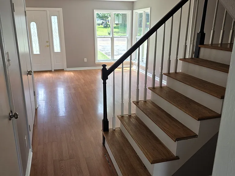 Stairs, half bath first door on the left