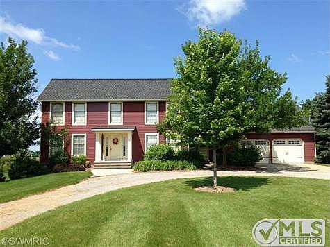 Front of immaculate saltbox home with attached 2-stall garage.