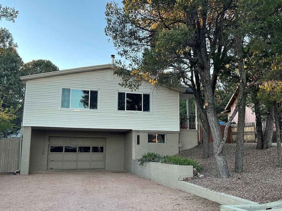 Front of house. Parking in garage, lower driveway, and upper driveway.