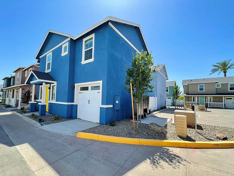 Another single family home and view of guest parking and mailbox center.