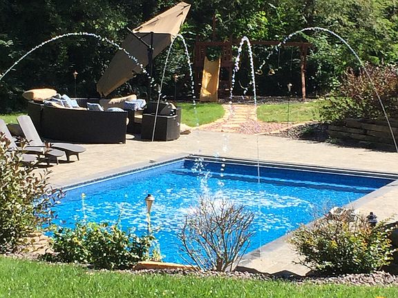 Water jets arching into pool
